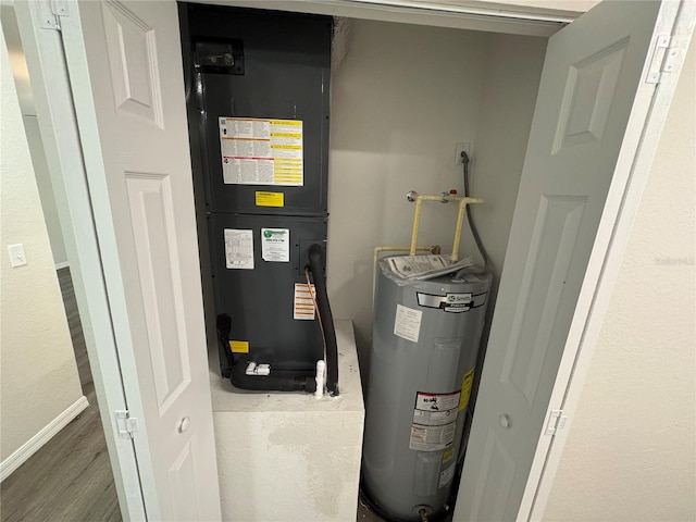 utility room featuring water heater and heating unit