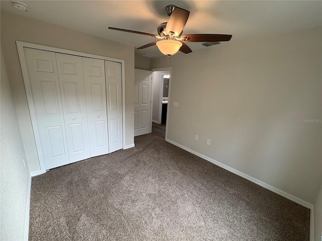 unfurnished bedroom with carpet floors, a closet, a ceiling fan, and baseboards