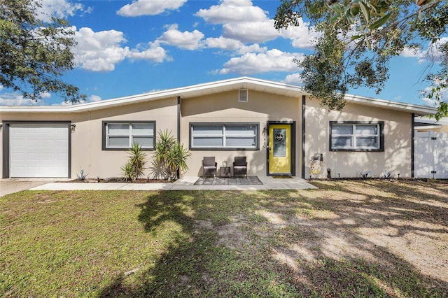 view of front of property featuring a front yard and a garage