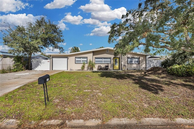 ranch-style house featuring a garage and a front yard