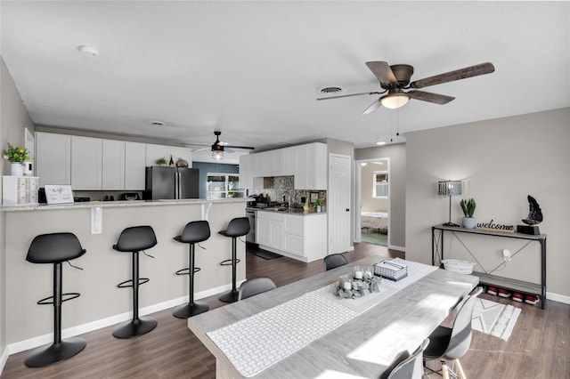 dining area featuring dark hardwood / wood-style floors and ceiling fan