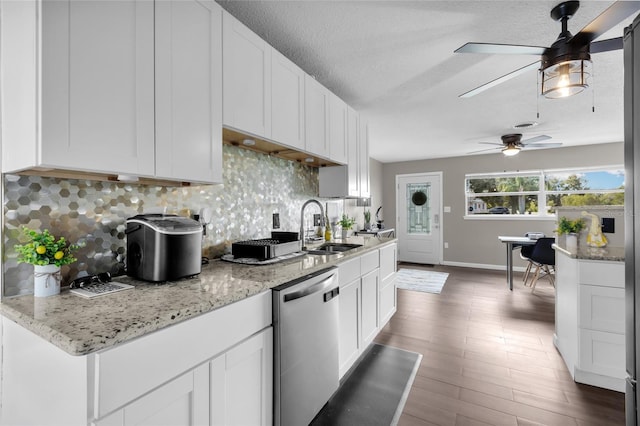 kitchen featuring white cabinetry, sink, tasteful backsplash, dark hardwood / wood-style flooring, and stainless steel dishwasher