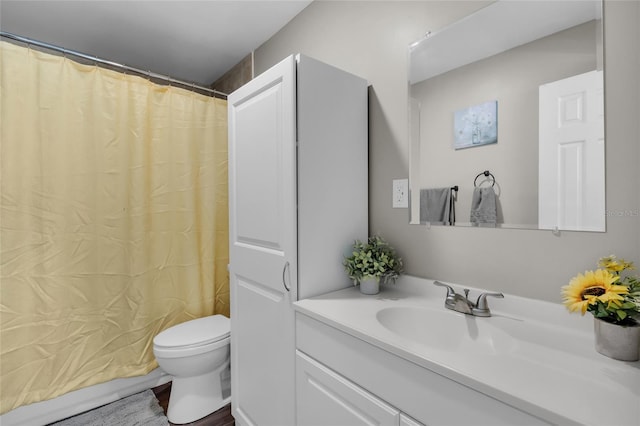 bathroom with walk in shower, hardwood / wood-style floors, vanity, and toilet