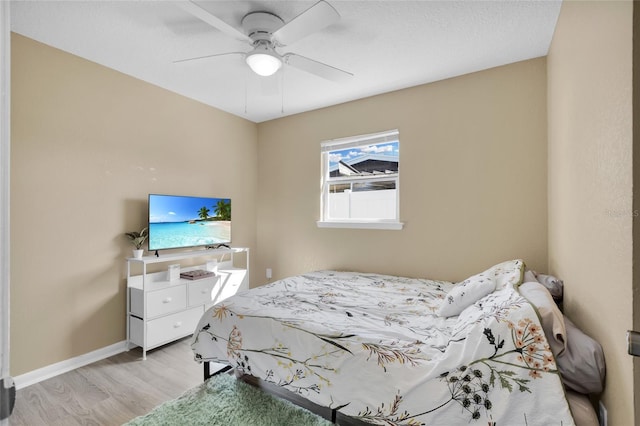 bedroom with ceiling fan and light wood-type flooring