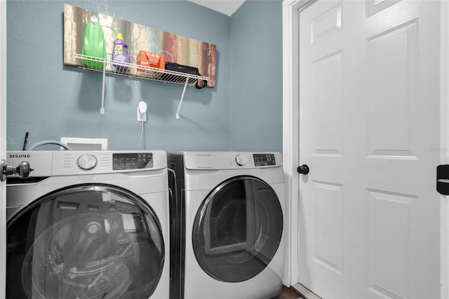 laundry area featuring washing machine and clothes dryer