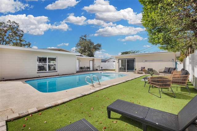 view of pool with outdoor lounge area, a yard, and a patio