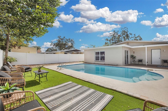 view of pool with a yard and a patio