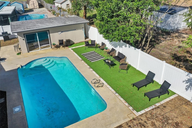 view of swimming pool with a lawn and a patio