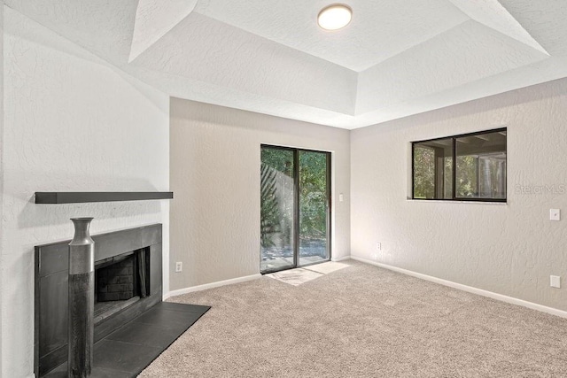 unfurnished living room with carpet floors and a textured ceiling