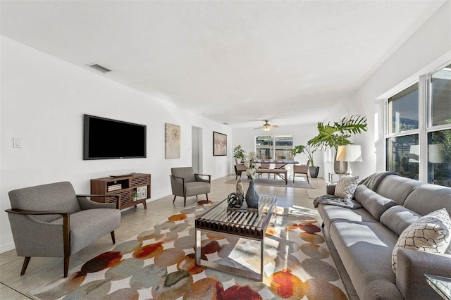 living room featuring ceiling fan and light tile patterned flooring