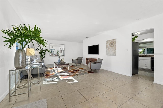 living room with sink and light tile patterned flooring