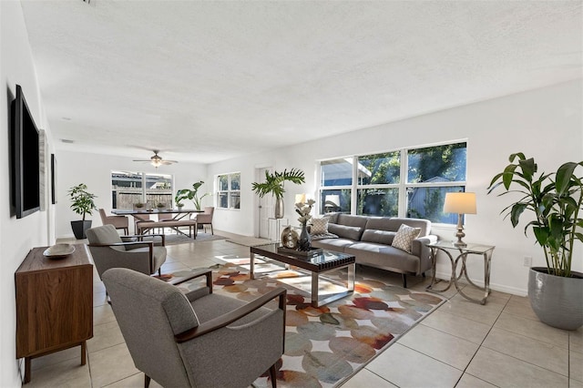 tiled living room with ceiling fan and a textured ceiling