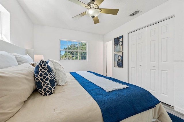 bedroom featuring wood-type flooring, a closet, and ceiling fan