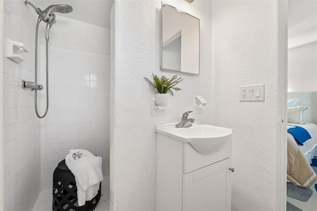 bathroom featuring vanity and tiled shower