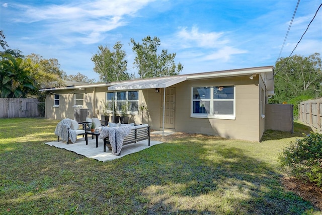 rear view of house featuring a lawn, outdoor lounge area, and a patio area