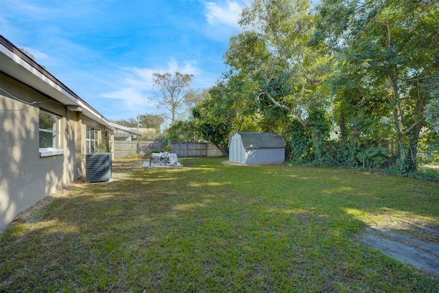 view of yard featuring a storage shed and central air condition unit