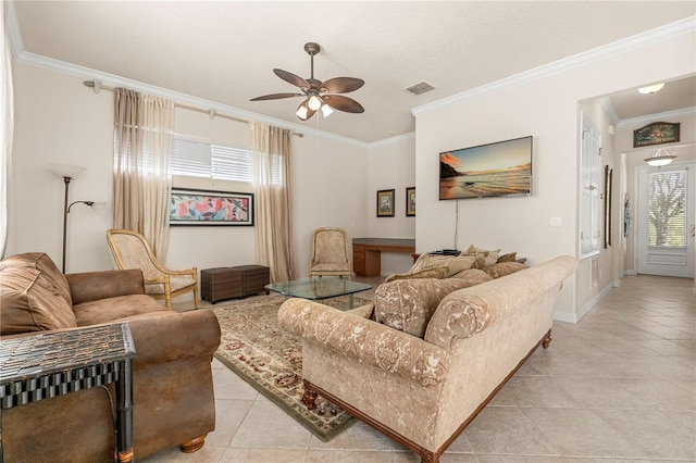 living room with ceiling fan, light tile patterned flooring, and ornamental molding