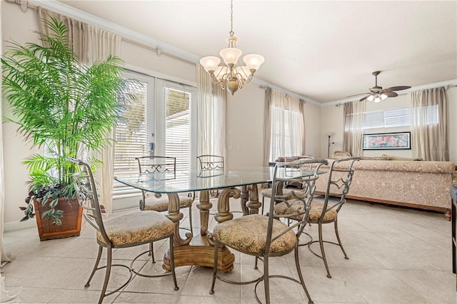 tiled dining space featuring ceiling fan with notable chandelier and ornamental molding