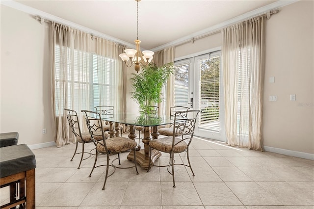 tiled dining area with crown molding, french doors, and a chandelier