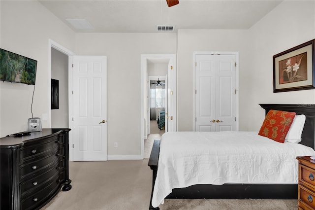 carpeted bedroom with ceiling fan and a closet