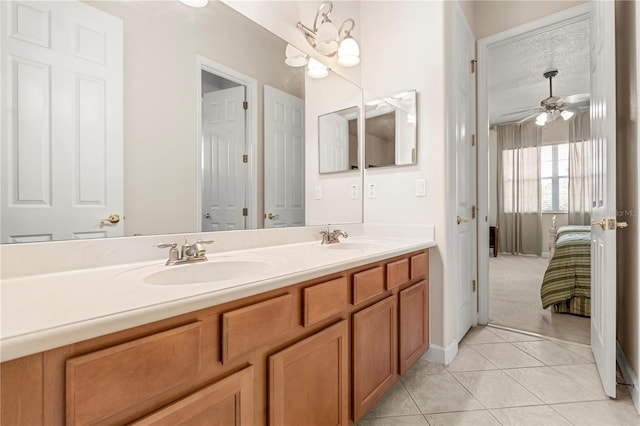 bathroom featuring tile patterned floors, ceiling fan with notable chandelier, a textured ceiling, and vanity