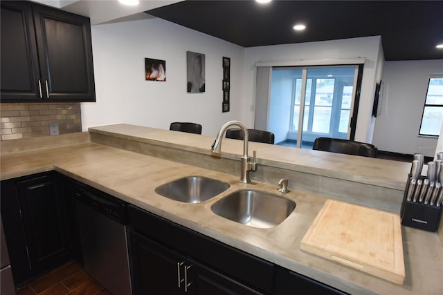 kitchen featuring sink, decorative backsplash, dark hardwood / wood-style floors, black dishwasher, and kitchen peninsula