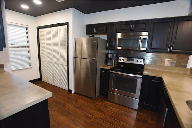 kitchen featuring backsplash, stainless steel appliances, and dark wood-type flooring