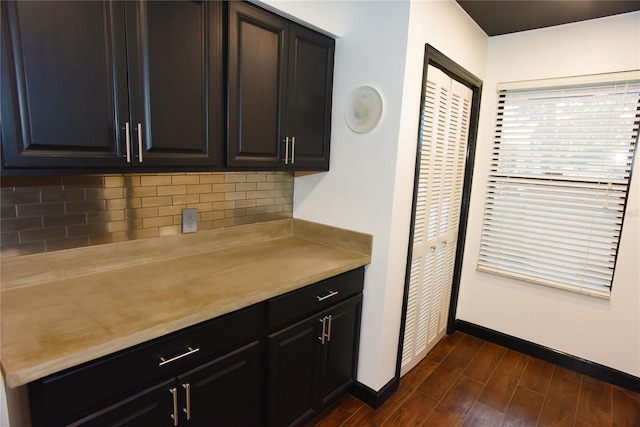 kitchen with dark hardwood / wood-style floors and tasteful backsplash