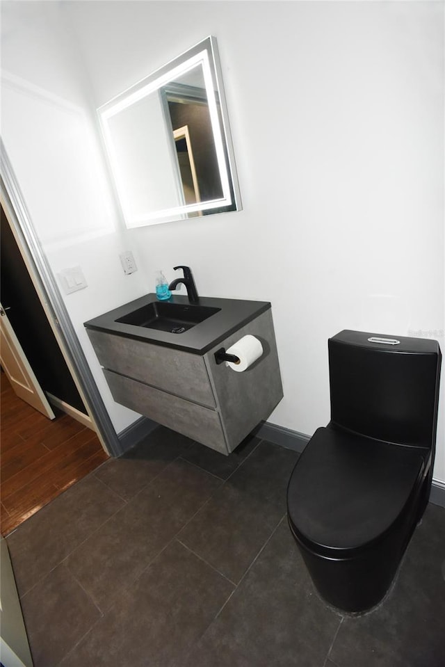 bathroom featuring vanity, toilet, and wood-type flooring