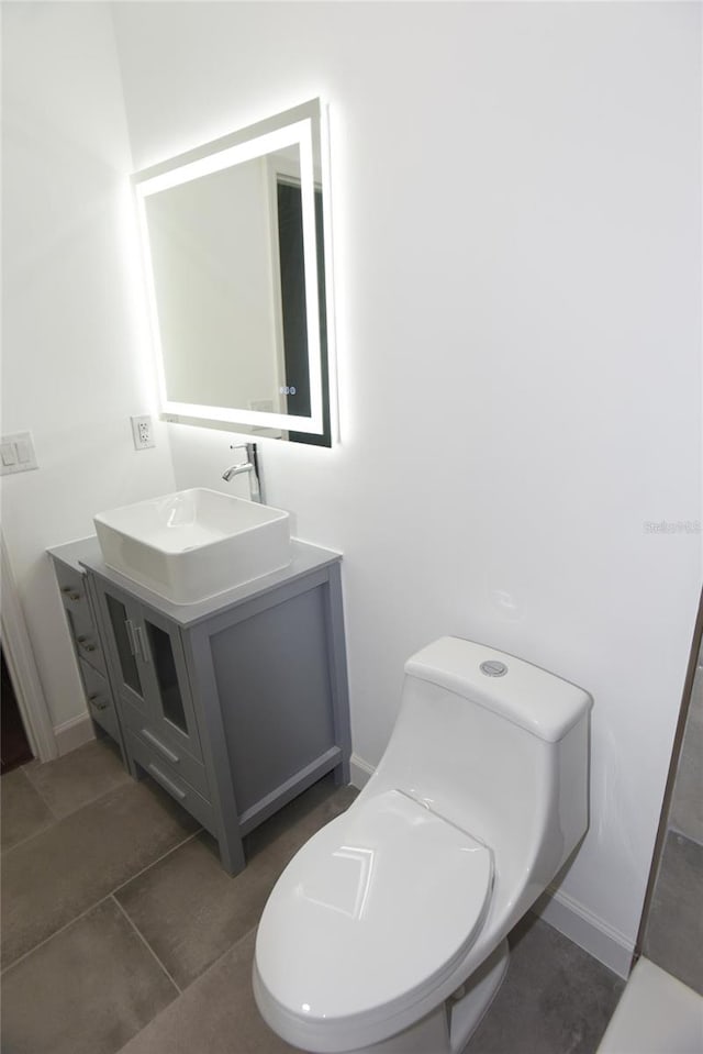 bathroom with tile patterned floors, vanity, and toilet