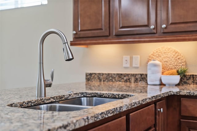 kitchen with stone countertops and sink