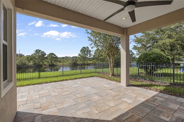 view of patio / terrace featuring ceiling fan and a water view