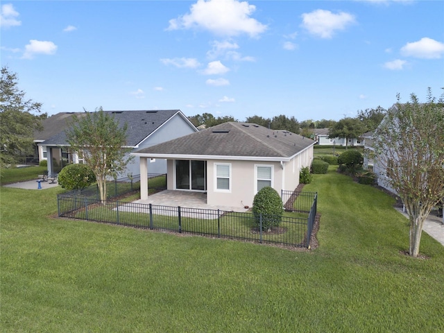 back of property with a patio area and a yard