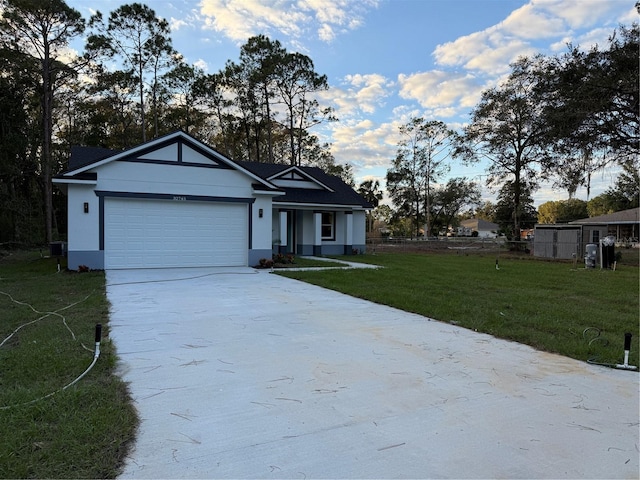 view of front of property featuring a front lawn and a garage