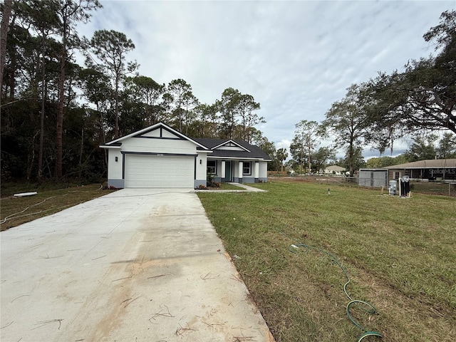 view of front of property featuring a front lawn and a garage