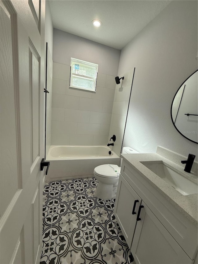 full bathroom with tile patterned floors, tiled shower / bath combo, toilet, and vanity