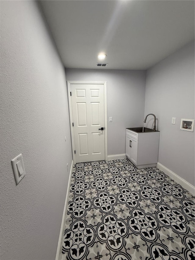 laundry room featuring cabinets