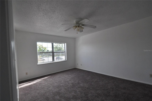 carpeted spare room with a textured ceiling and ceiling fan