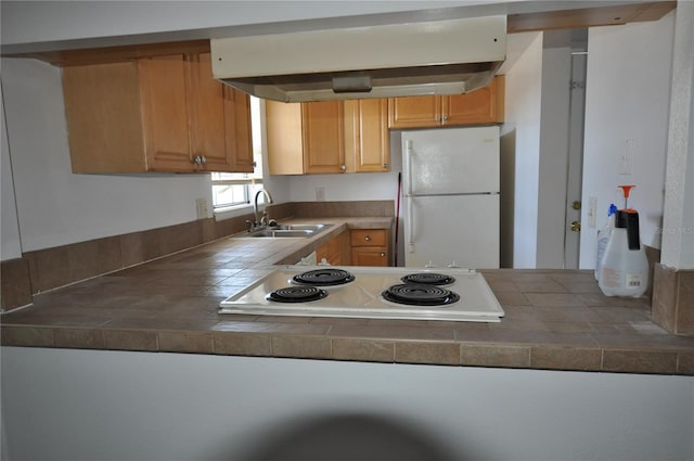 kitchen featuring tile countertops, white appliances, and sink