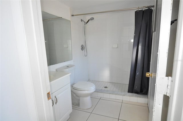 bathroom with tile patterned floors, curtained shower, vanity, and toilet