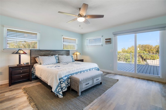 bedroom featuring access to exterior, ceiling fan, and light wood-type flooring