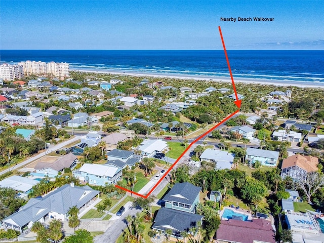 bird's eye view featuring a water view and a beach view