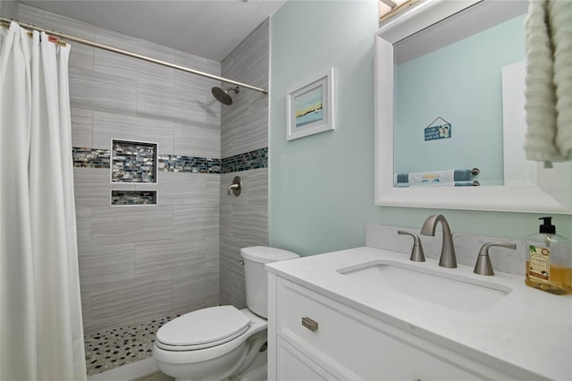 bathroom with vanity, toilet, and curtained shower