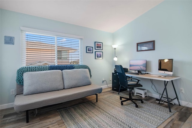 home office with wood-type flooring and lofted ceiling