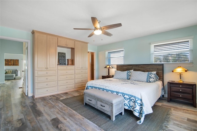 bedroom featuring dark hardwood / wood-style flooring, a closet, and ceiling fan