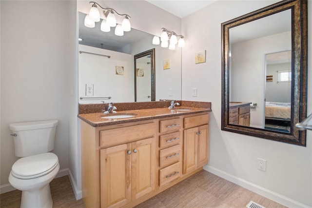 bathroom with vanity and toilet