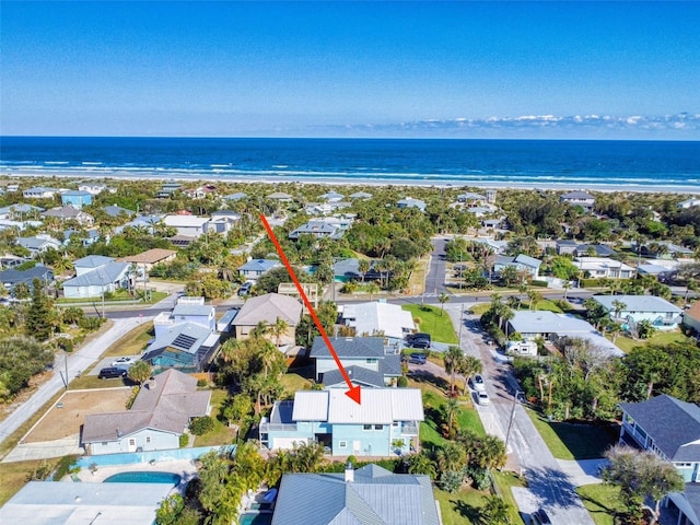 drone / aerial view with a water view and a beach view