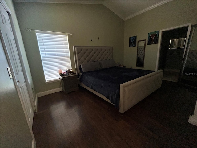 bedroom with dark hardwood / wood-style floors, crown molding, and vaulted ceiling