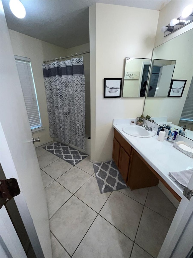 bathroom with a shower with curtain, tile patterned flooring, and vanity