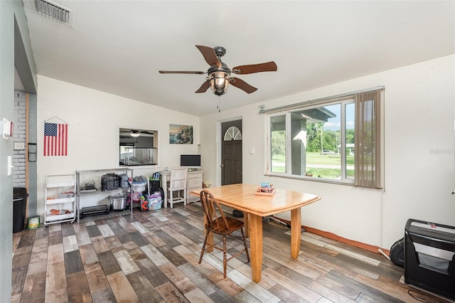 dining area with hardwood / wood-style flooring, vaulted ceiling, and ceiling fan